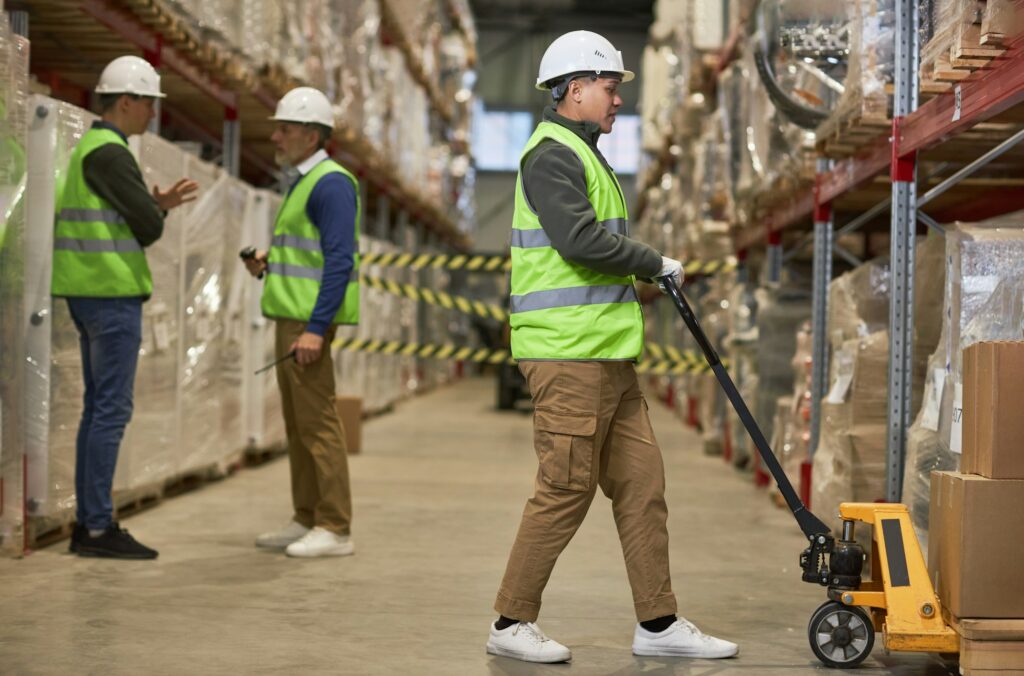 Shot of three workers doing operations in storage warehouse